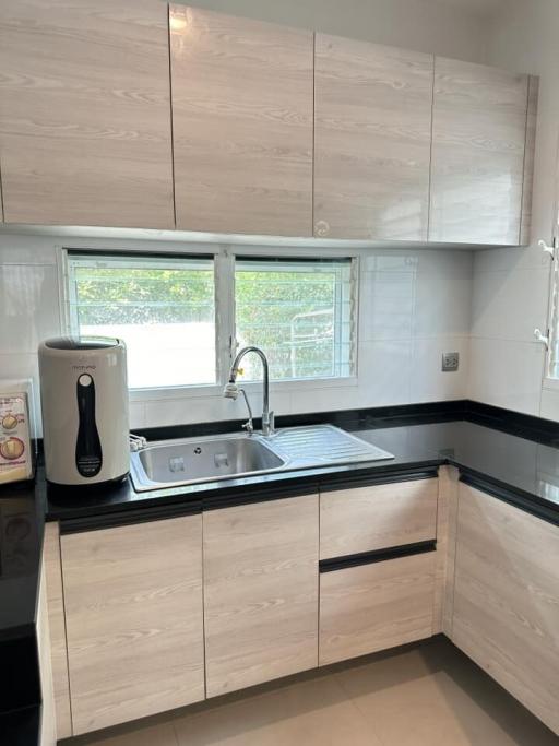 Modern kitchen with wooden cabinets and black countertop