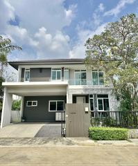 Modern two-story house with garage and landscaped front yard