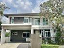 Modern two-story house with garage and landscaped front yard