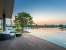 Modern home exterior with pool and seating area at dusk