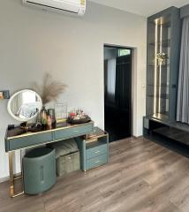 Stylish bedroom interior with a modern vanity table, elegant lighting, and air conditioning