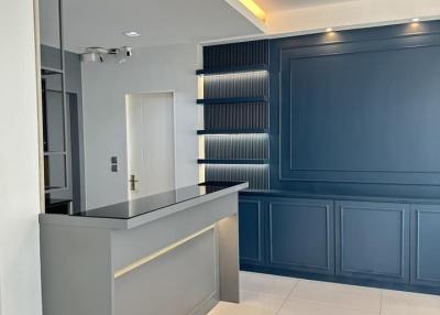 Modern kitchen with blue cabinetry and ambient lighting