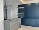 Modern kitchen with blue cabinetry and ambient lighting