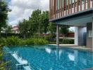 Luxurious outdoor swimming pool with adjacent building and natural landscape