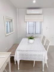 Modern dining room with white décor and air conditioning