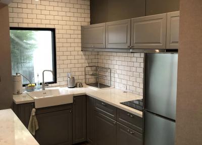 Modern kitchen with stainless steel appliances and subway tiles