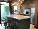 Modern kitchen with central island and designer pendant lights