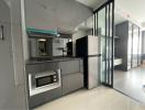 Modern kitchen with stainless steel appliances and gray cabinetry