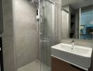 Modern bathroom interior with glass shower and basin