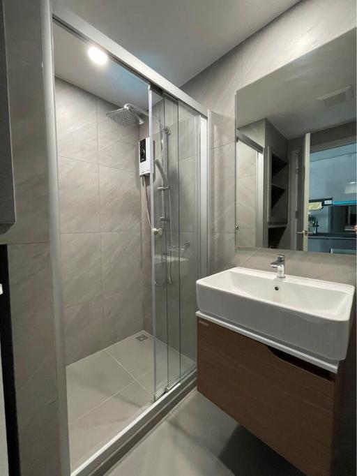 Modern bathroom interior with glass shower and basin