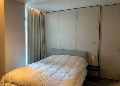 Modern bedroom with large bed and built-in wardrobes