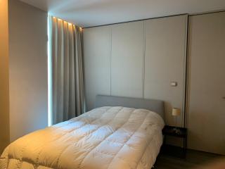 Modern bedroom with large bed and built-in wardrobes