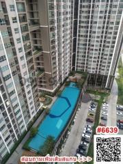 High-rise residential buildings with a swimming pool and parking lot