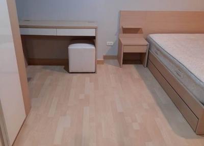 Compact bedroom with wooden flooring and minimalist furniture