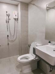 Modern bathroom interior with wall-mounted sink and toilet with a shower system