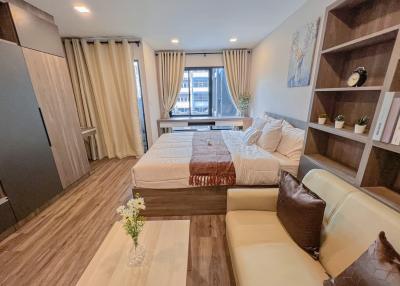 Modern bedroom with ample natural light and cozy furnishings