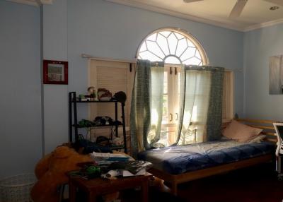 Cozy bedroom with natural light and a large arched window