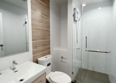 Modern bathroom with walk-in shower and wooden accents