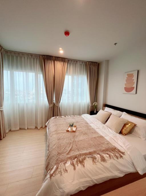 Cozy bedroom with large window and elegant decor