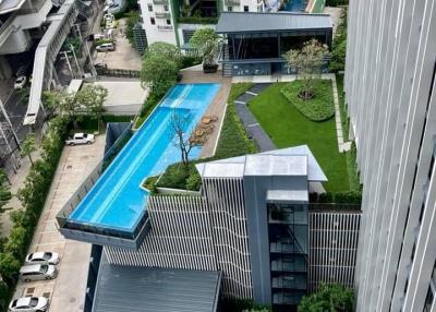 High angle view of a modern apartment complex with swimming pool and landscaped garden