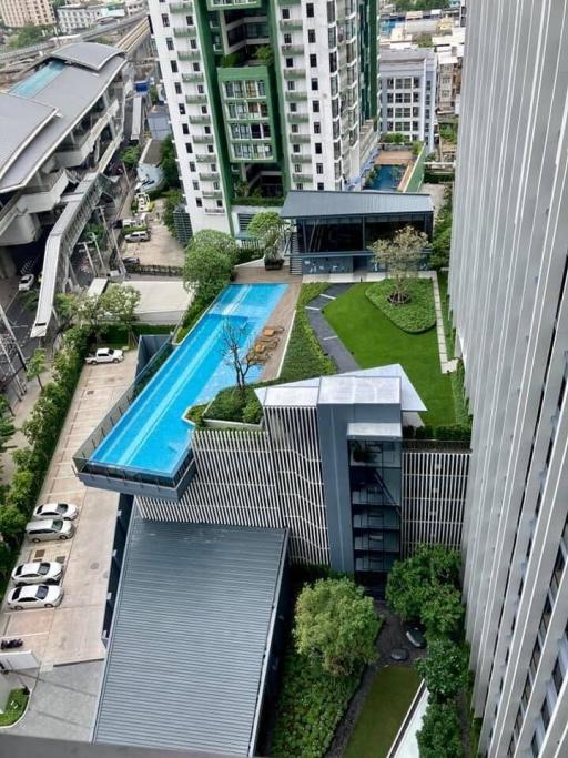 High angle view of a modern apartment complex with swimming pool and landscaped garden