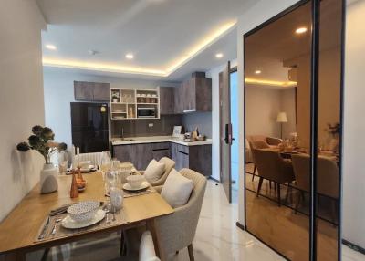 Modern kitchen with integrated dining space featuring marble flooring and elegant decor