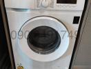 Front-load Samsung washing machine installed in a home laundry area