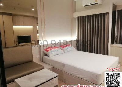 Modern furnished bedroom with ample lighting and cozy decor