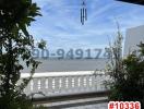 Seaside balcony with ocean view and wind chimes