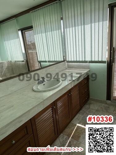 Spacious bathroom with large vanity and abundant natural light