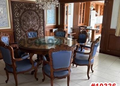 Elegant dining room with chandelier, carved wooden chairs and large table