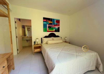 Spacious bedroom with modern art and ensuite bathroom