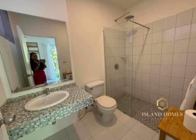 Spacious bathroom with double sinks and walk-in shower