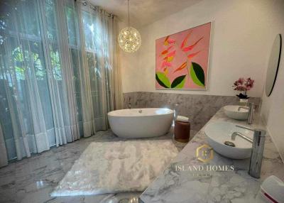 Modern bathroom with freestanding tub and marble flooring