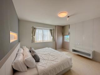 Modern bedroom with large bed and natural light