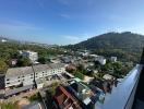 Panoramic view from a high vantage point overlooking a cityscape with buildings and greenery