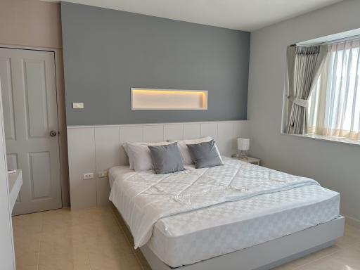 Modern bedroom with a large bed and soft color palette
