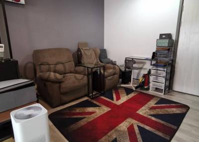Modern living room with brown sofas and a British flag rug
