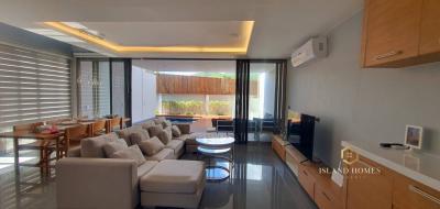 Modern living room with open dining area and natural light