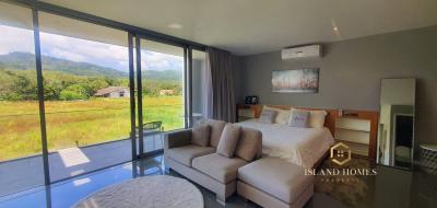 Modern bedroom with large windows and scenic view