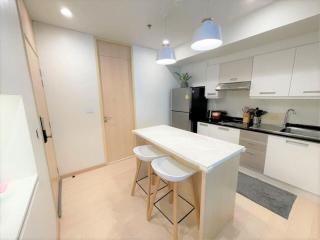 Modern kitchen with white cabinetry and breakfast bar