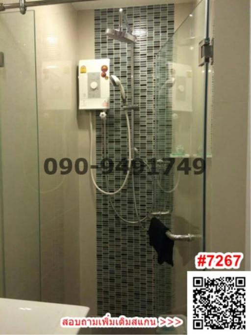 Modern bathroom equipped with a glass shower enclosure and electric shower unit