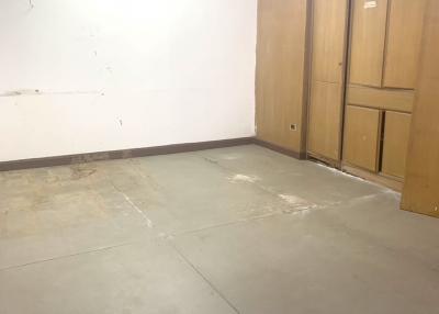 Empty room with concrete floor and wooden doors