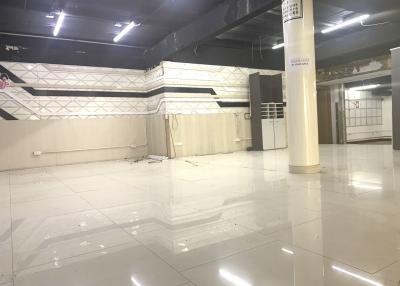 Spacious interior of an empty building with tiled floors