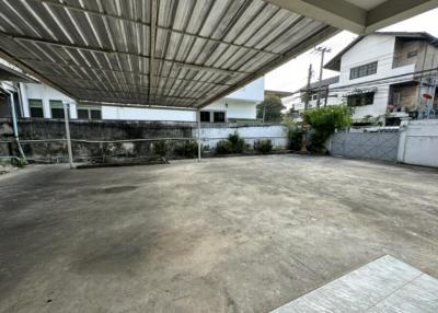 Spacious outdoor parking area with covered roofing