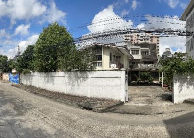 Suburban house with white fence and clear sky