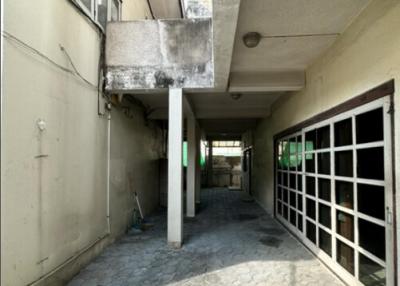 Concrete structure with large windows and paved floor