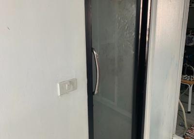 Frosted glass door leading to a restroom in a building
