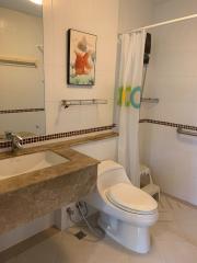 Clean bathroom with shower, marble countertop, and framed artwork