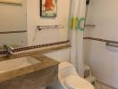 Clean bathroom with shower, marble countertop, and framed artwork